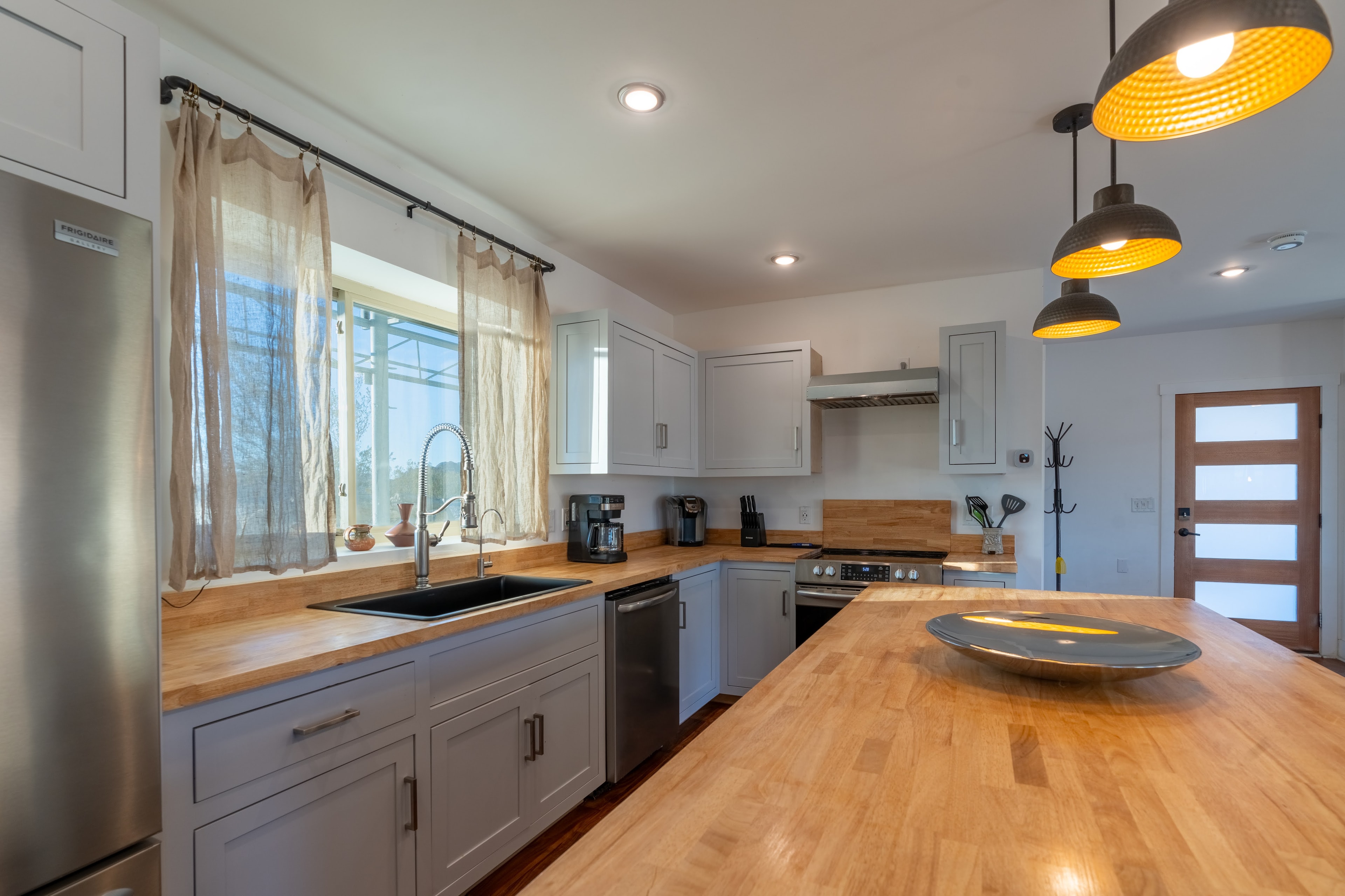 Kitchen with wood countertops and pendant lights