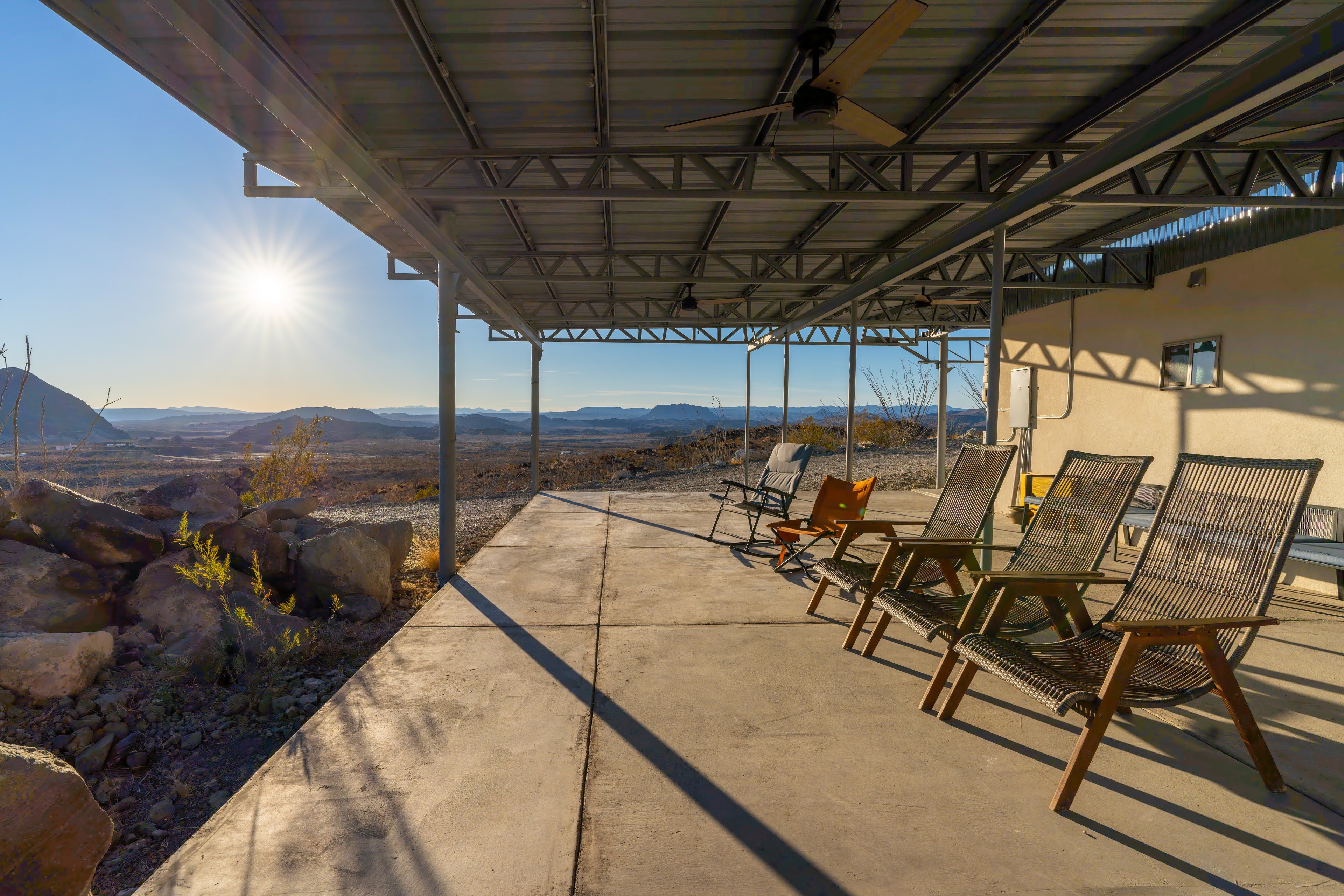 Desert patio with lounge chairs overlooking mountains
