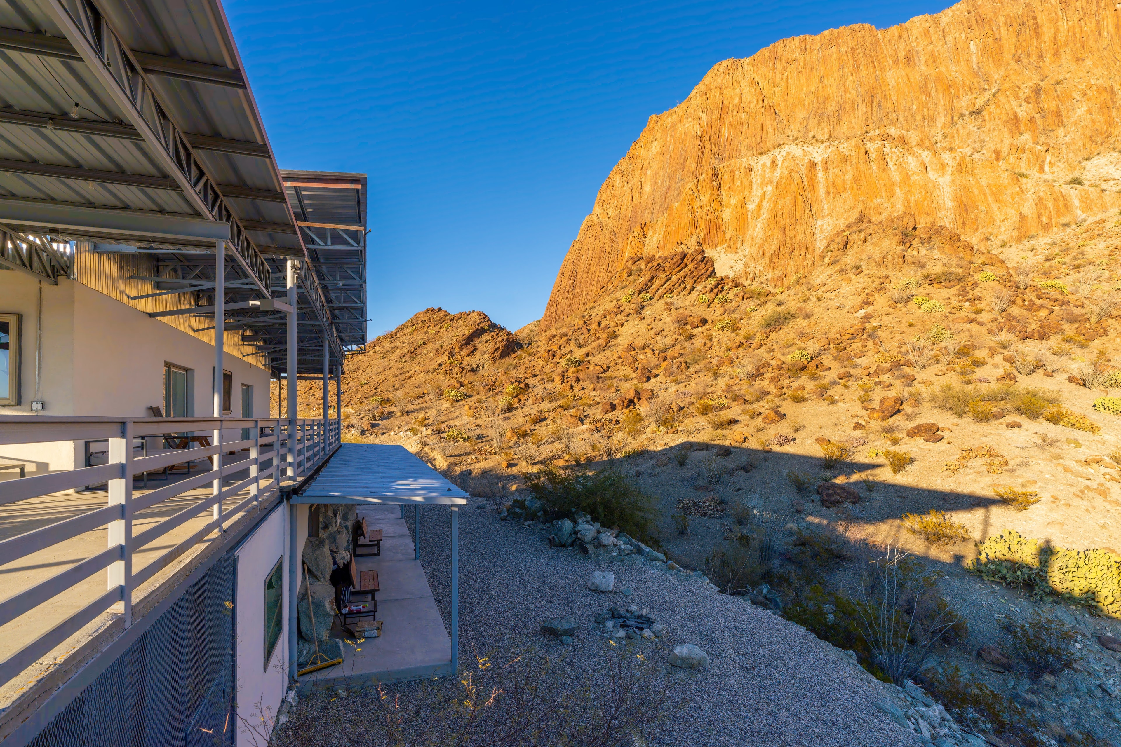 Modern desert home in rocky canyon landscape